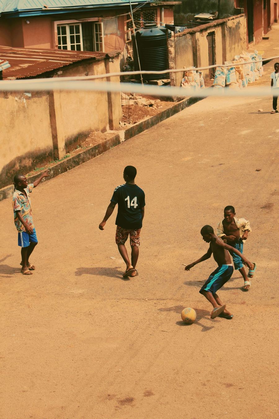 Kids playing street football in a Nigerian neighbourhood