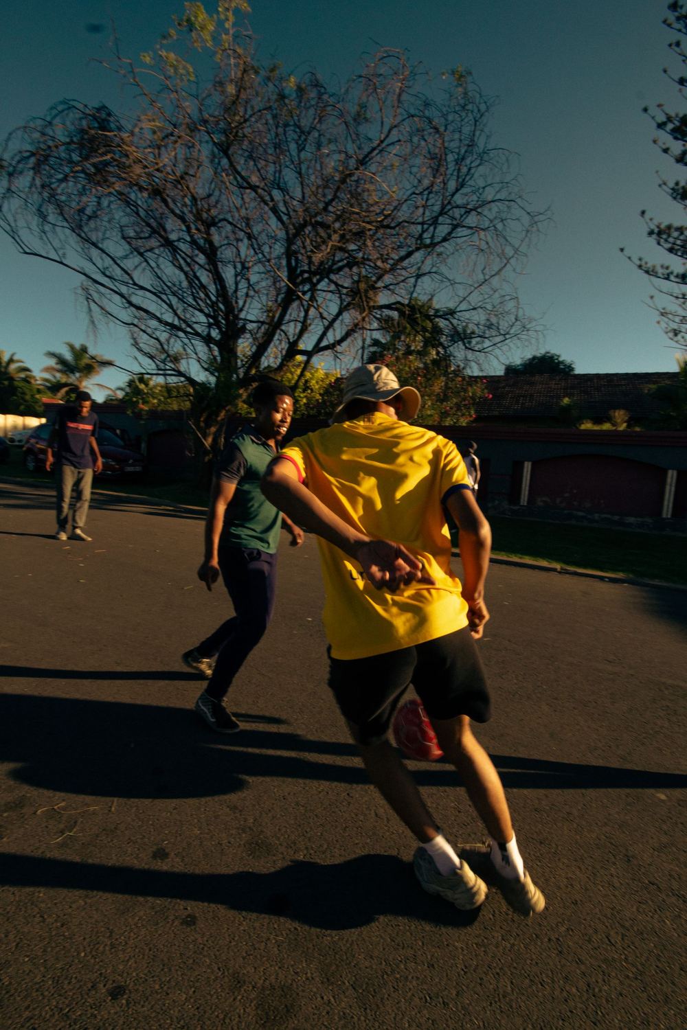 Players in a fast street five-a-side game at golden hour